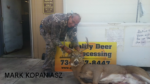 Man holding killed buck