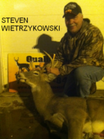 Man holding killed buck