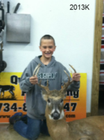 Man holding killed buck