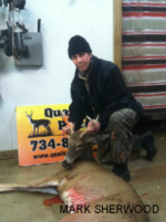 Man holding killed buck