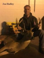 Man holding killed buck