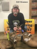 Man holding 2 killed bucks