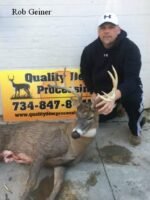 Man holding killed buck