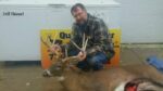 Man holding killed buck