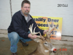 Man holding killed buck