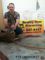 Man holding killed buck