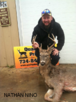 Man holding killed buck