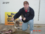 Man holding killed buck