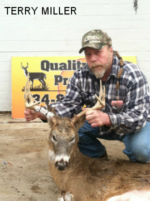 Man holding killed buck