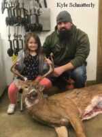 Man and girl holding killed buck