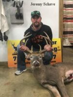 Man holding killed buck