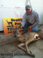 Man holding killed buck
