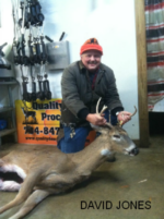 Man holding killed buck