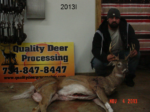 Man holding killed buck