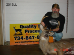 Man holding killed buck