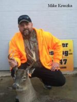 Man holding killed buck