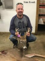 Man holding killed buck