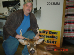 Man holding killed buck