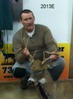 Man holding killed buck