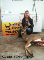 Man holding killed buck