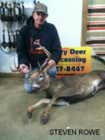 Man holding killed buck