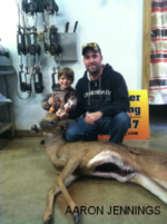Man holding killed buck