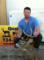 Man holding killed buck