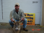 Man holding killed buck