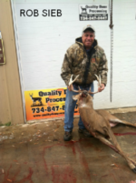 Man holding killed buck