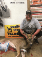 Man holding killed buck