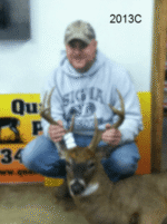 Man holding killed buck