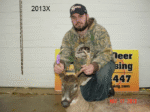 Man holding killed buck
