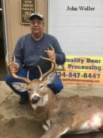 Man holding killed buck