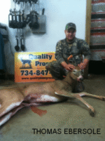 Man holding killed buck