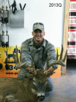 Man holding killed buck