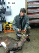 Man holding killed buck