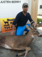 Man holding killed buck