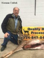 Man holding killed buck