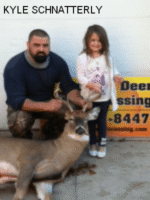 Man and girl holding killed buck