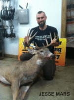 Man holding killed buck