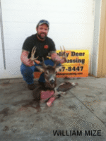 Man holding killed buck