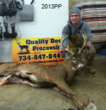 Man holding killed buck