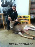 Man holding killed buck