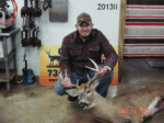Man holding killed buck