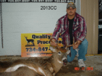Man holding killed buck